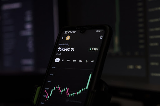 A candlestick chart with red and green candles of Bitcoin prices on a phone